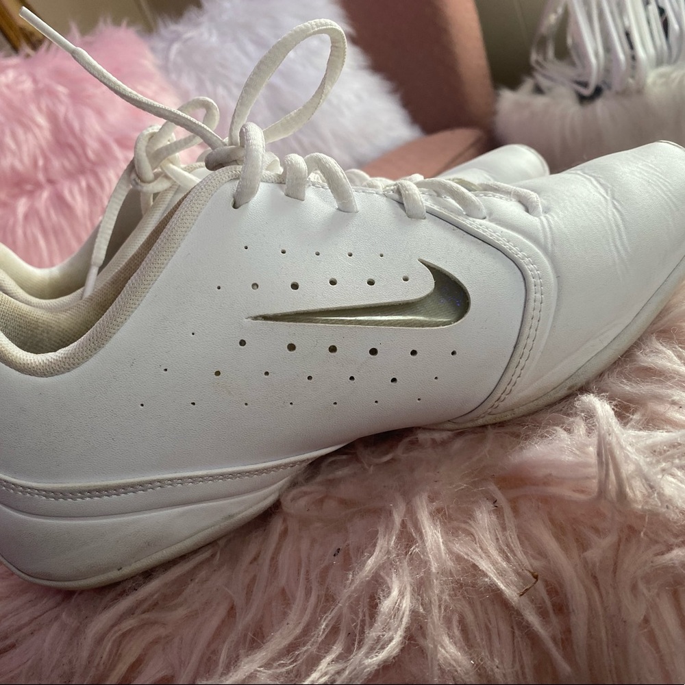 White Nike cheer shoes with replaceable color Nike symbol.
